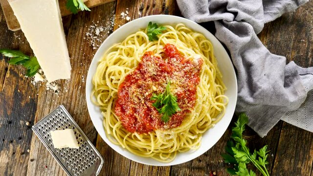 spaghetti with tomato sauce and parmesan