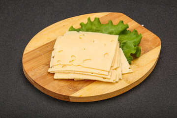 Sliced yellow cheese over board