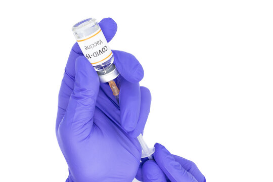 Hands of a doctor or nurse filling a syringe with the vaccine of Covid-19