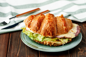 Croissant stuffed with bacon, cheese and lettuce