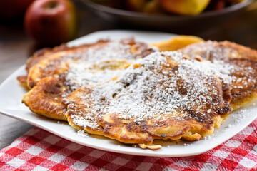 homemade apple pancakes sprinkled with powdered sugar.