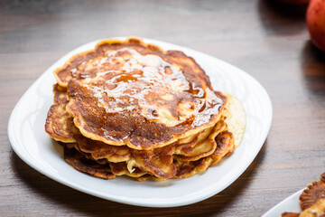 homemade pancakes with apples poured with honey.