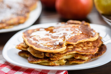 homemade pancakes with apples poured with honey.