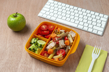 Lunch at workplace healthy pasta with tuna, tomatoes, in lunch box