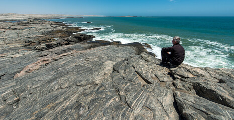 Man is watching Diaz Point, Namibia