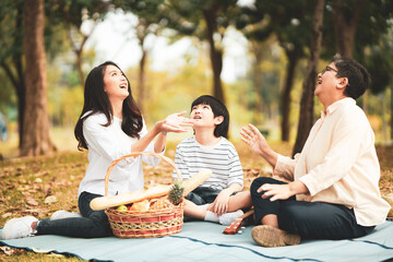 Asian family having good time together in the park.