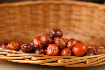 dry orange jujubes fruits in a wicker basket