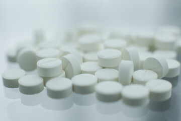 White pills on glass table