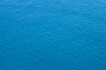 Fototapeta na wymiar Blue little waves sea breeze, background