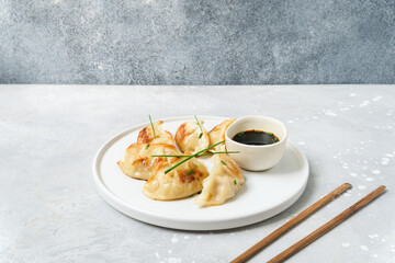 Takeout coronavirus food. Gyoza Japanese dumplings with soy sauce. Asian cuisine. typical food Japanese Chinese Korean. delivery takeaway