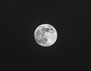 Full moon on the background of the night sky in winter. Black and white photo