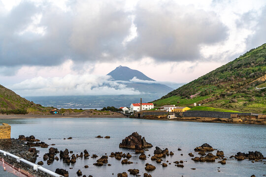 Azores, Island of Faial, the bay of Horta with the beach of Porto Pim and the old Wale fabric. In the background the Pico Mountain  from Pico Island