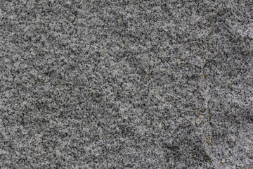 Gray embossed texture of natural stone. Granite background.