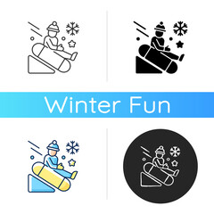 Snow tubing icon. Fun children ride downhill. Extreme sledging. Winter activity. Festive season recreation for kids. Linear black and RGB color styles. Isolated vector illustrations