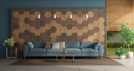 Blue sofa in front of a wall with hexagonal wooden tiles