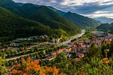 A picturesque panoramic view of a French alpine village Puget-Theniers in the valley of Var river during sunset (Provence, Alpes-Maritimes, France)