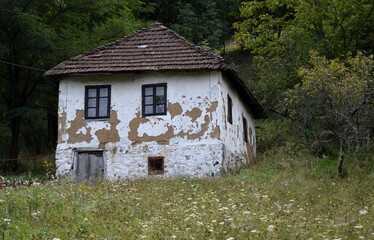 an old abandoned white country house