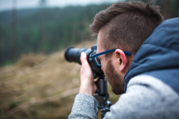 man looking through a camera