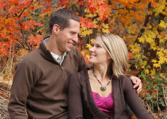 Fototapeta premium attractive young couple close and looking at each other in autumn