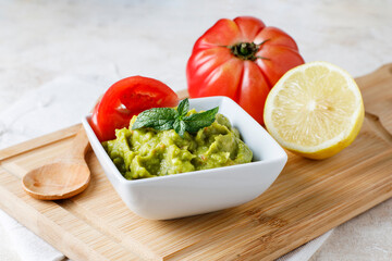 Guacamole sauce with tomato and lemon