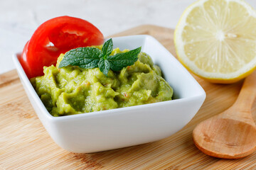 Guacamole sauce with tomato and lemon