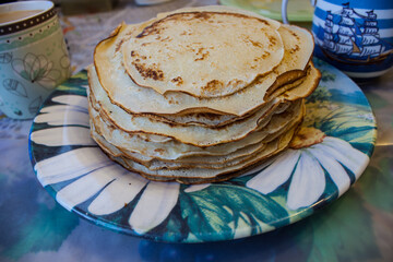Stack of traditional russian pancakes blini on gray background with copy space. Homemade russian...