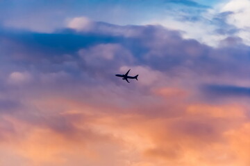 Airplane against the sky with clouds at sunset in summer (background, banner, Wallpaper, texture)