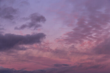 Naklejka na ściany i meble Dramatic sunrise, sunset pink violet blue sky with clouds background texture