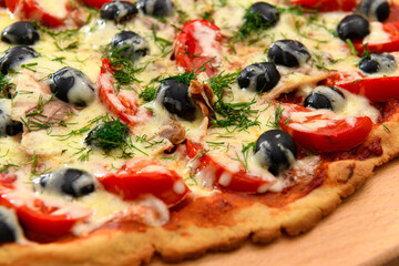 homemade pizza, vegetarian food, baked vegetables and cheese, tomatoes and olives, delicious food on a wooden background