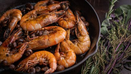 Jumbo shrimp grilled in skillet with rosemary and lemon