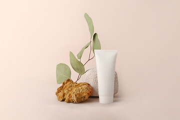 Composition from the natural materials and cosmetics tube near it.Copy space for text or design.Can be used as advertising banner.Pastel colors.Mockup concept.