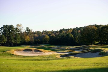 Hard and difficult golf course background at a luxury country club golf course - many sand bunkers and many hills and bumps on the hard golf course at a luxury resort lifestyle country club. 