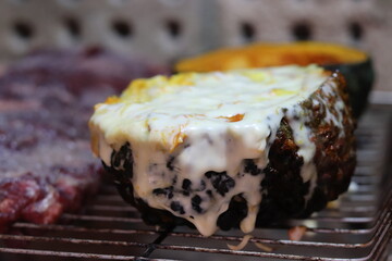 Pumpkin stuffed with cheese baked on the grill.