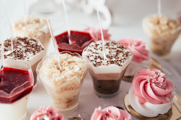 Banquet in the restaurant or cafe. Served table setting with fresh cupcakes sweets, candies with jelly and sugar. Gourmet tiramisu italian dessert birthday tasty chocolate. 