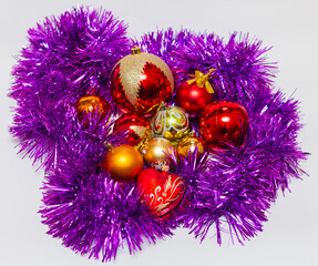 Red and gold Christmas balls with purple tinsel