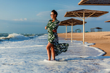 Girl in dress posing on the beach