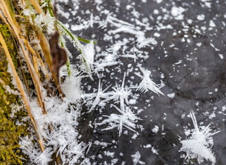 Snow crystals on the ice of the river in winter