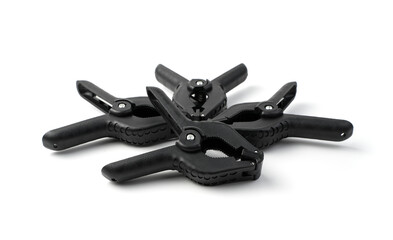 A set of black clips isolated on a white background. Concept of accessories for equipment.