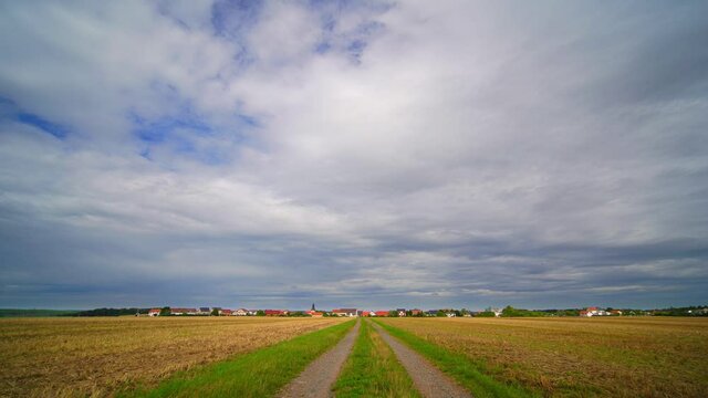 Time lapse of rolling clouds on blue sky over green field background