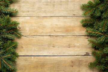 Wooden background with Christmas tree branches and snow. Christmas concept. Banner. Flat lay, top view