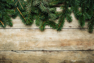 Wooden background with Christmas tree branches. Christmas banner