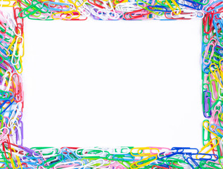 Frame made of colorful paper clips on white background,top view with space for text or creativity.Frame