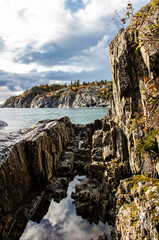 lake with clouds and rugged rock shore of Lake Superior at Pukaskwa National Park, Marathon, Ontario