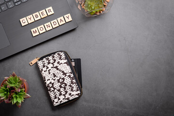 Obraz premium Cyber monday flat lay with wallet, credit card, laptop and succulent plant. Online shopping from home, safe shopping concept, top view, web banner