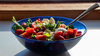 healthy Italian salad in a blue bowl
