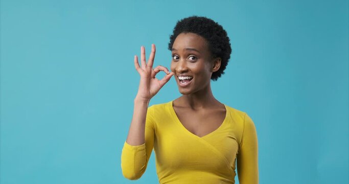 Happy african american woman showing ok hand sign