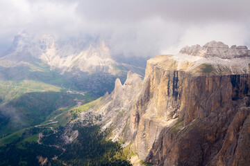 spectacular mountains in nice light coming over clouds, view to the valley from the top, italy, dolomites