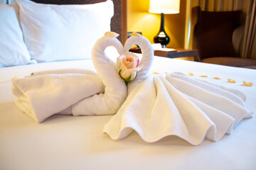 Fototapeta na wymiar Romantic folded swans in a honeymoon suite