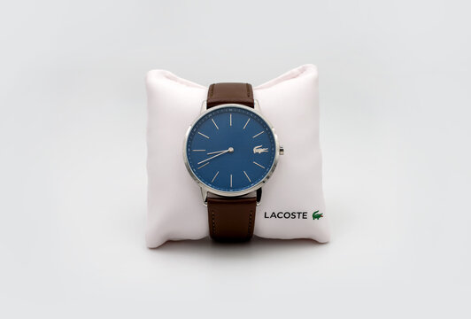 PARIS, FRANCE &ndash; AUGUST 19, 2019: Lacoste watch with deep blue dial and brown leather strap attached to a small cushion.