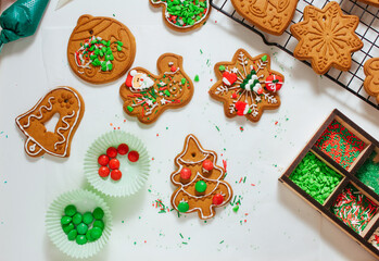 Christmas gingerbread cookies decorating by children with sprinkles